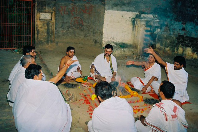 The other priests offer a mixture of grains whcih include rice and black sesame seeds (till).