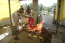 Offering a silk sari into the yagya fire.